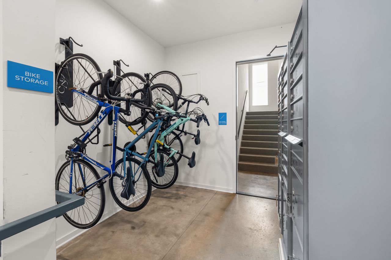 Services-02 Modern indoor bike storage area with multiple bikes securely mounted on wall racks.